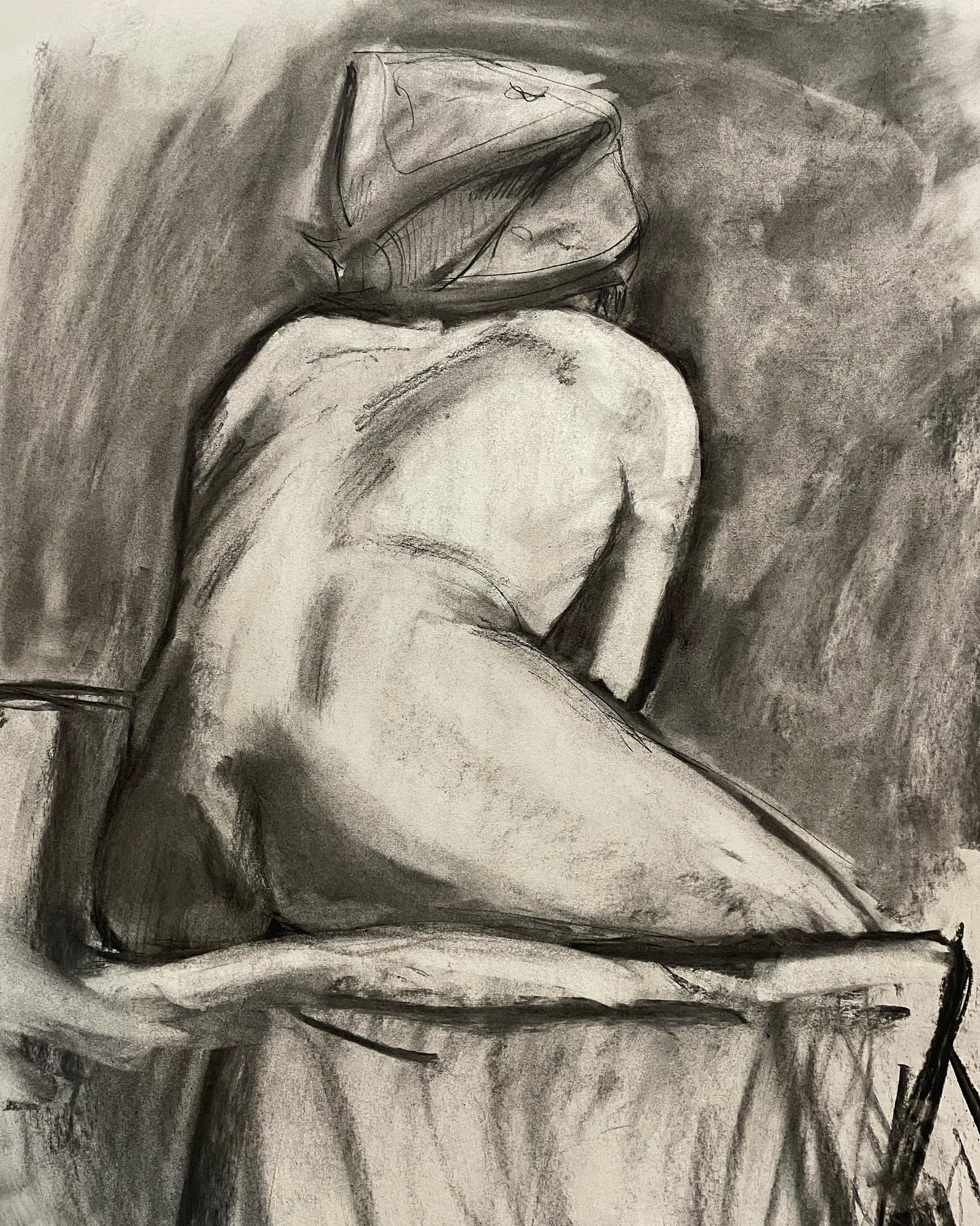 charcoal drawing of a the back of a seated nude woman